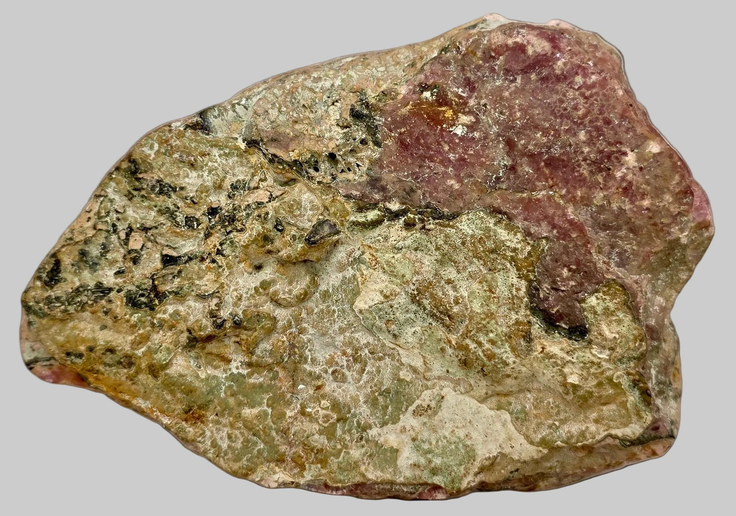 Rock with green and brown hues on a white background