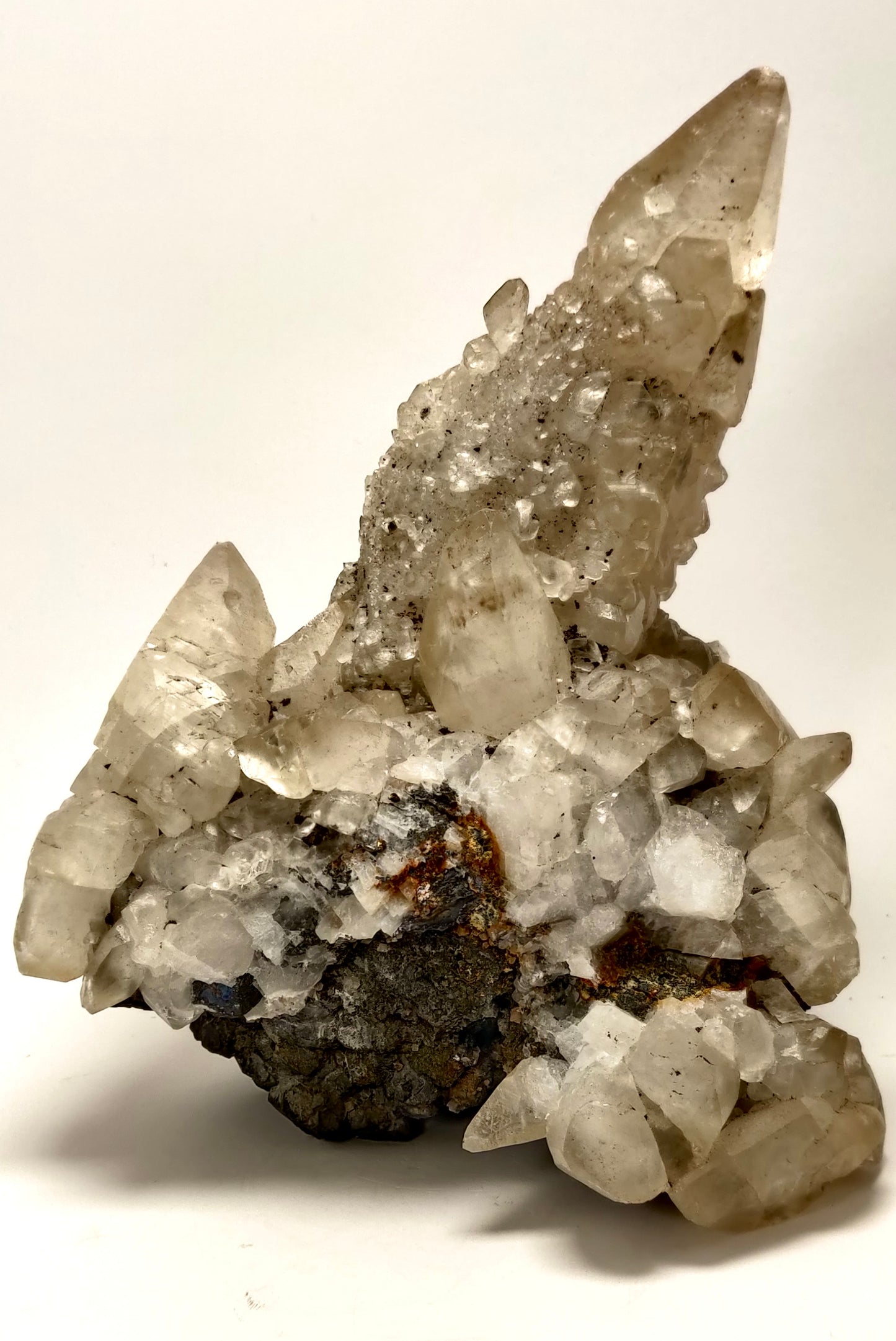 Mineral specimen with crystal formations on a white background
