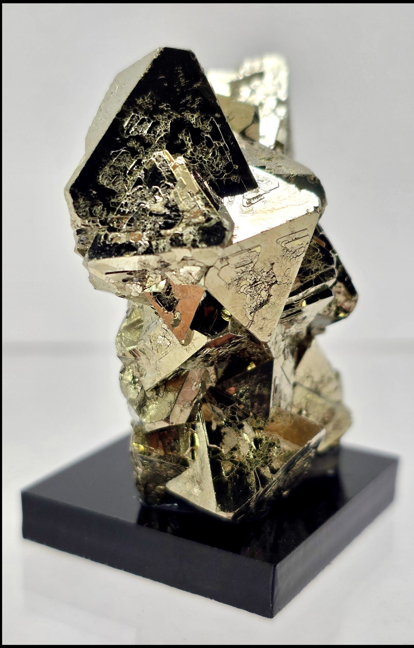 Mineral specimen on a black base against a gray background