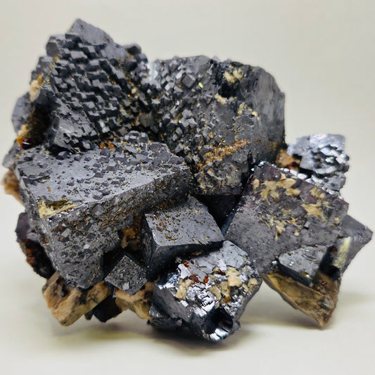 Mineral sample with a gray and black crystalline structure on a light background