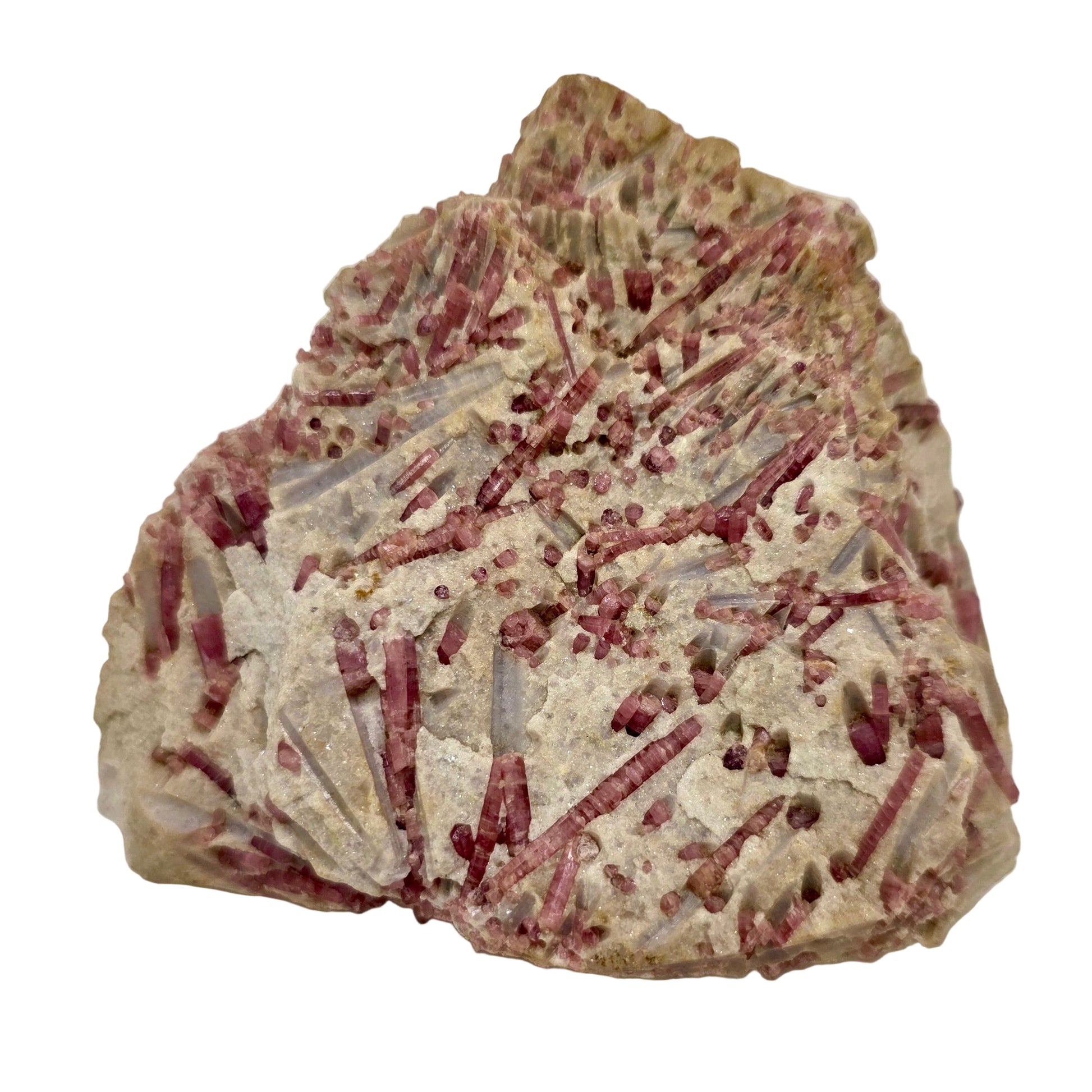 Mineral sample with red and white crystals on a beige background