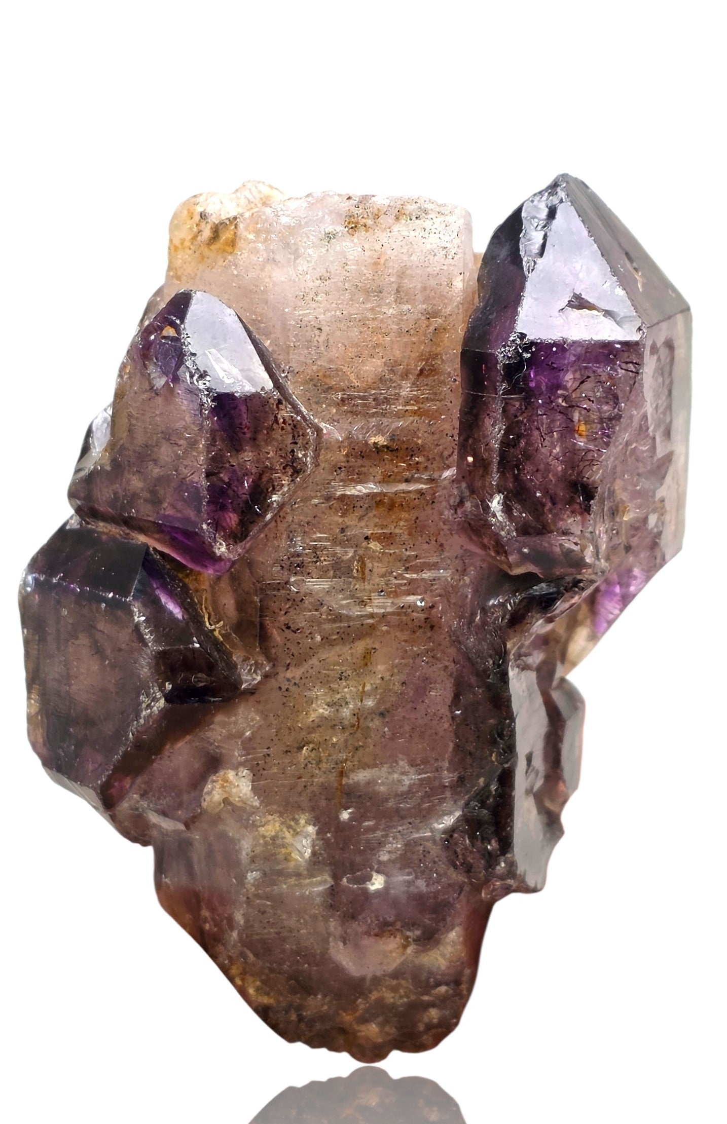 Crystal with purple and clear facets on a white background