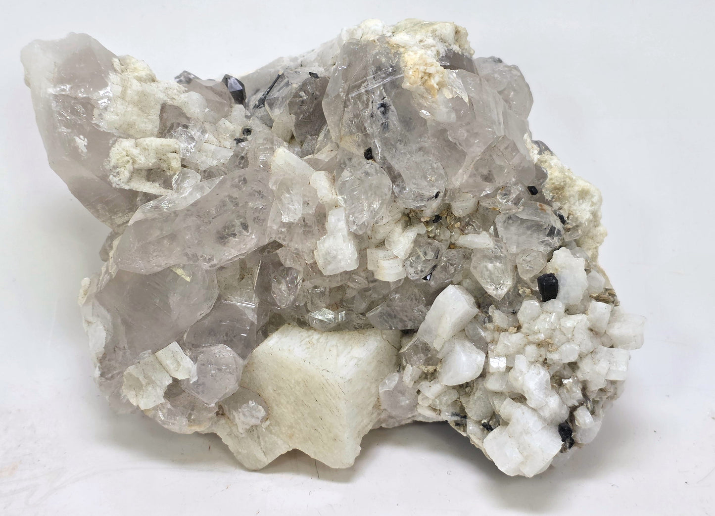 Mineral sample with crystal formations on a white background