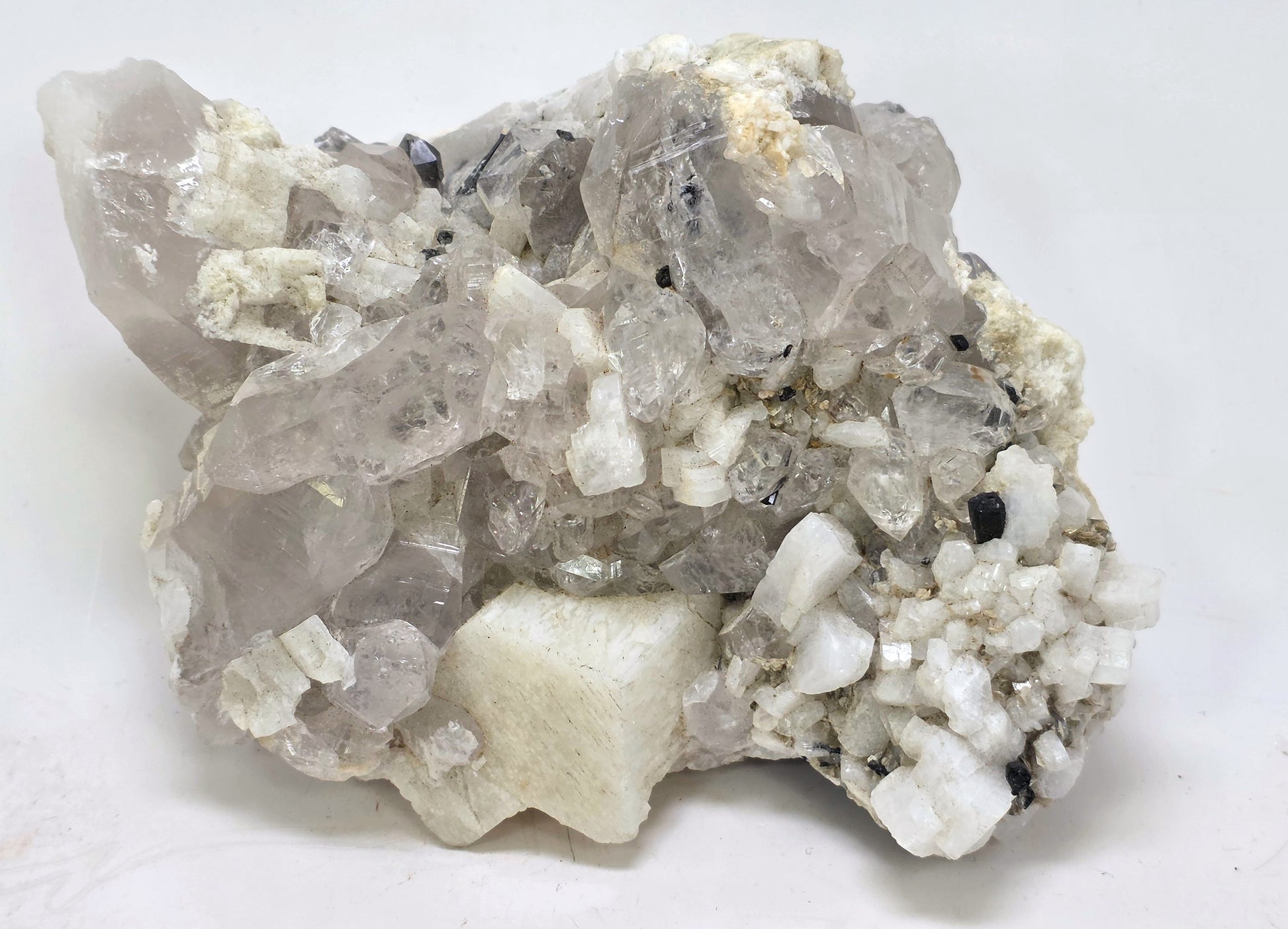 Mineral sample with crystal formations on a white background
