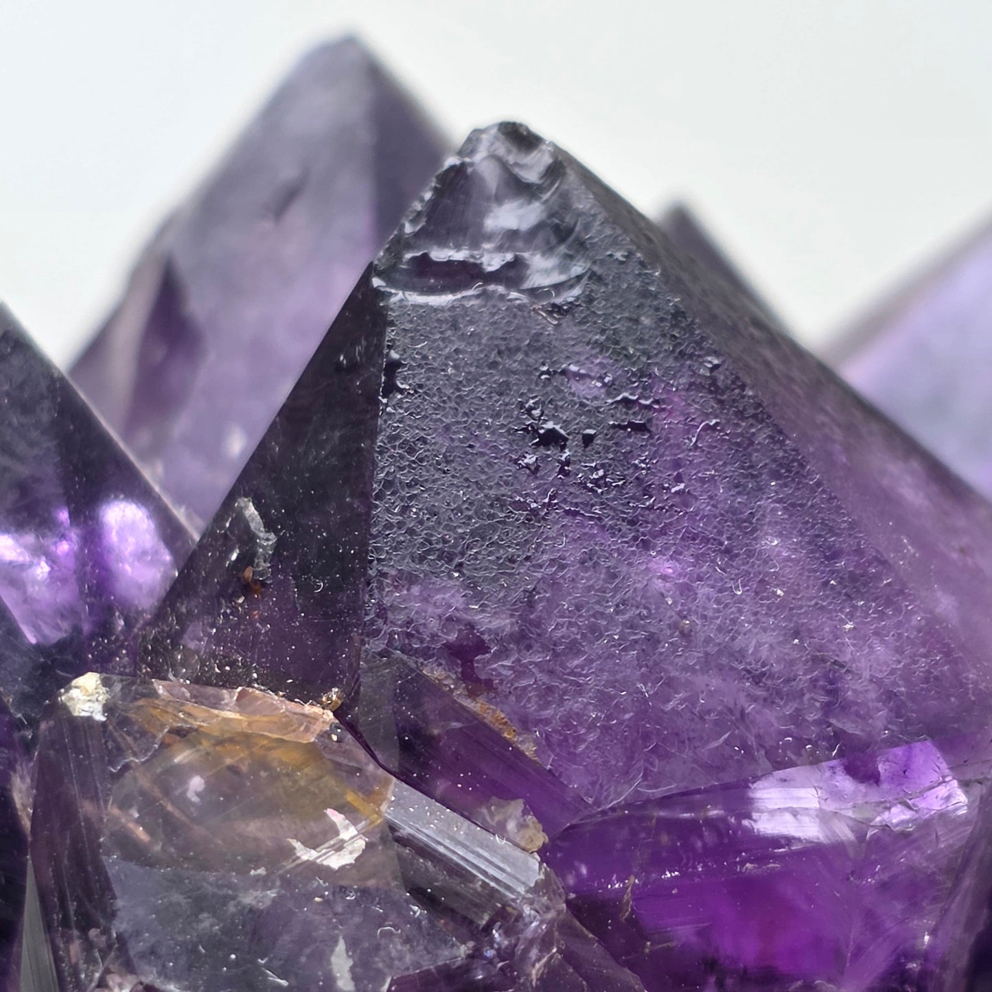 Close-up of purple crystal with a white background