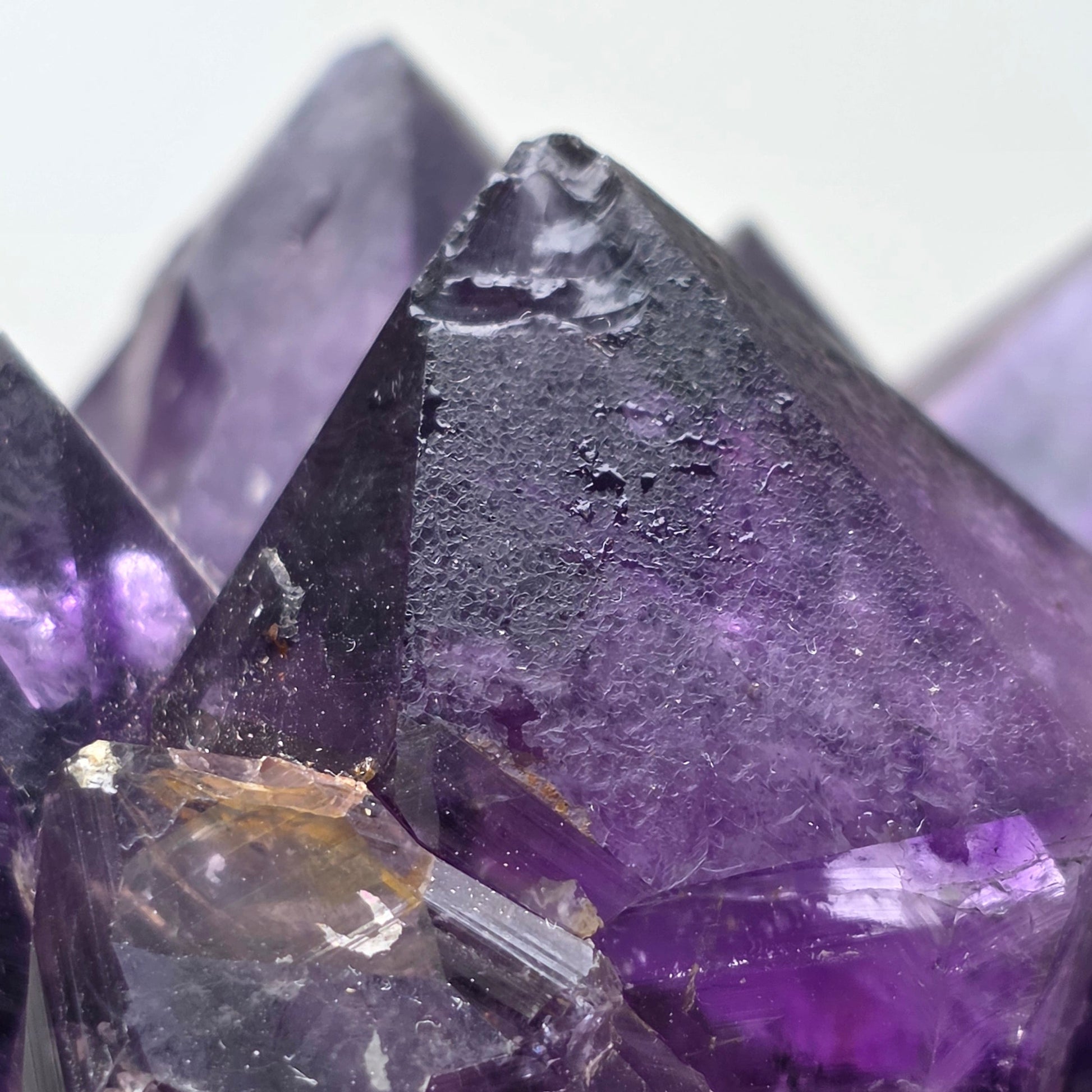 Close-up of purple crystal with a white background