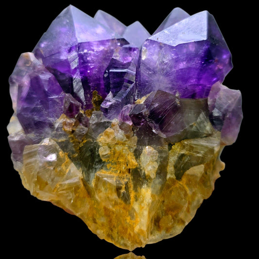 Amethyst crystal cluster on a black background