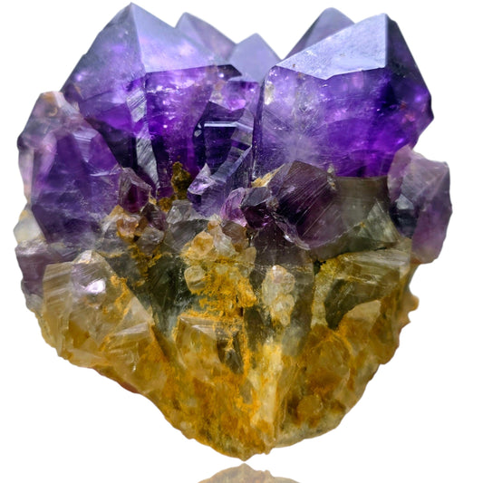 Amethyst crystal cluster on a white background