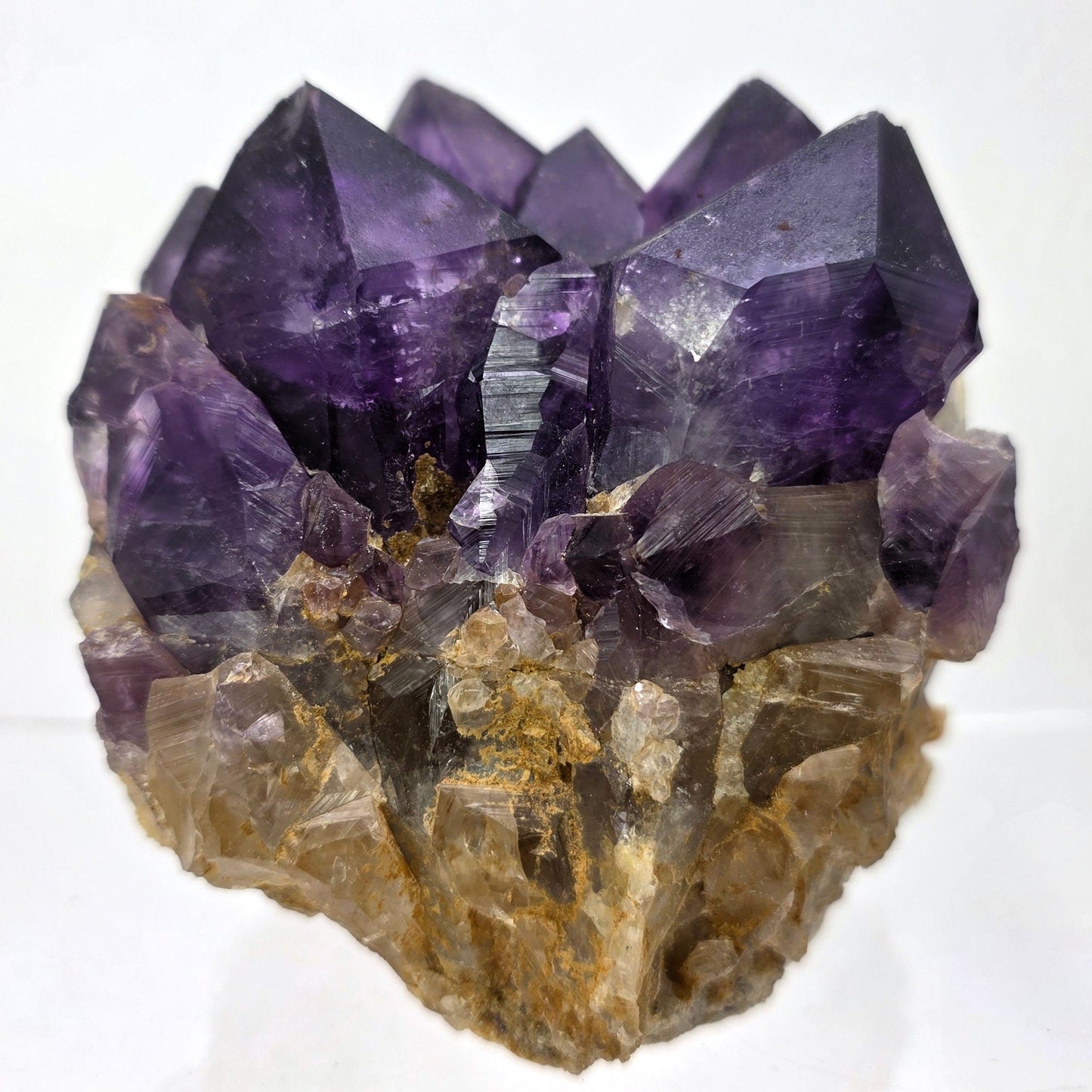 Amethyst crystal cluster on a white background