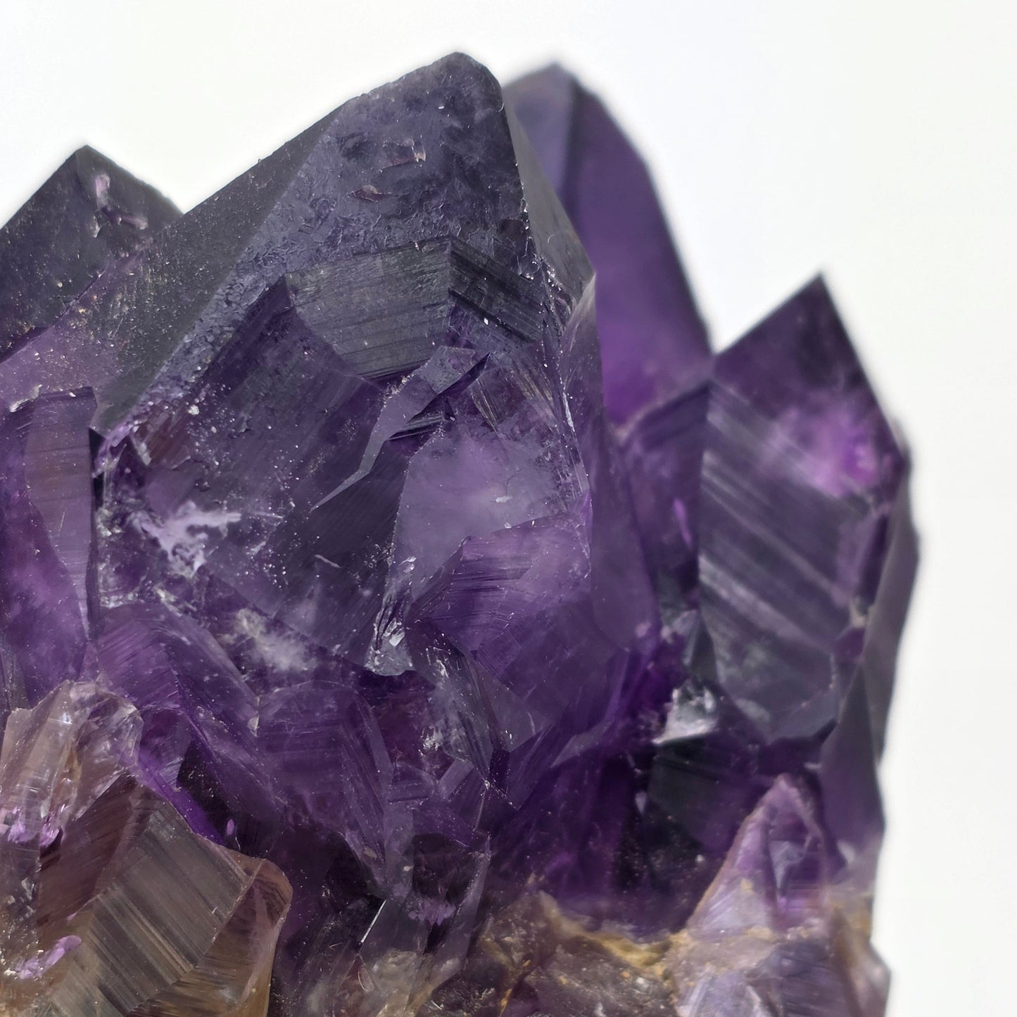 Close-up of purple and brown crystal formations on a white background