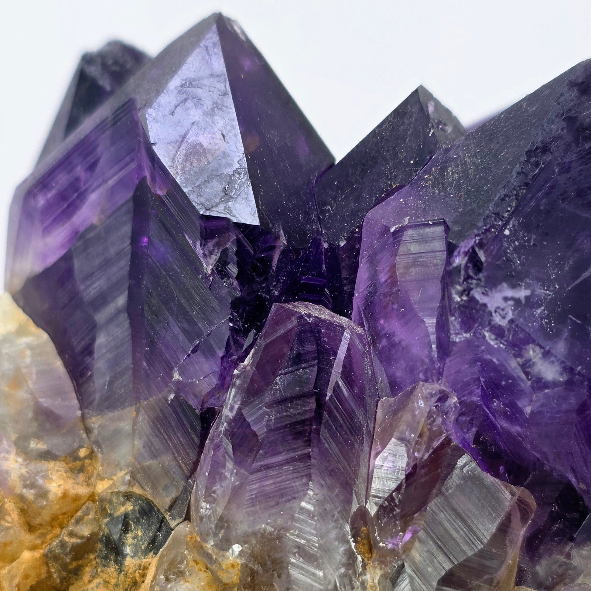 Close-up of purple crystal formations on a white background