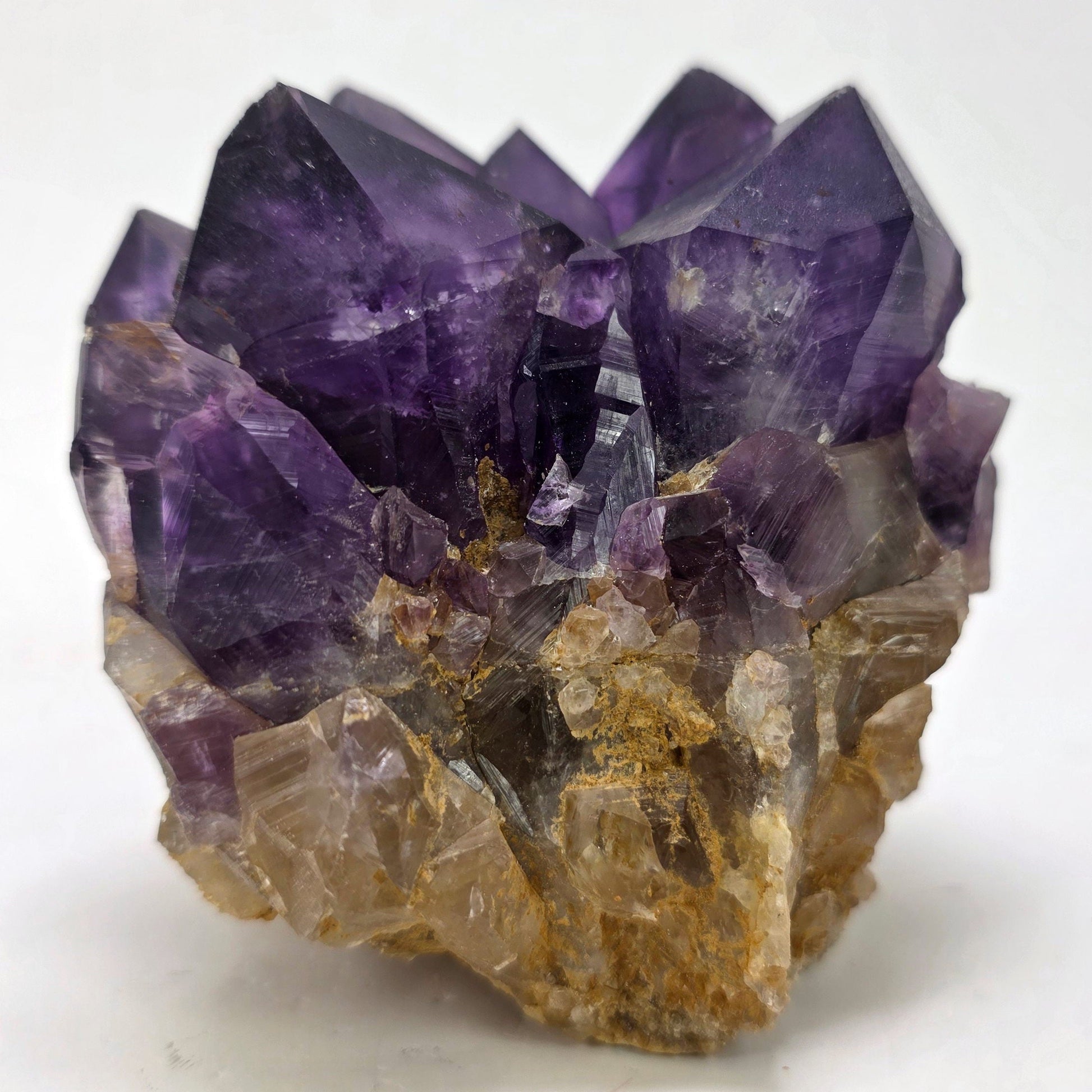 Amethyst crystal cluster on a white background