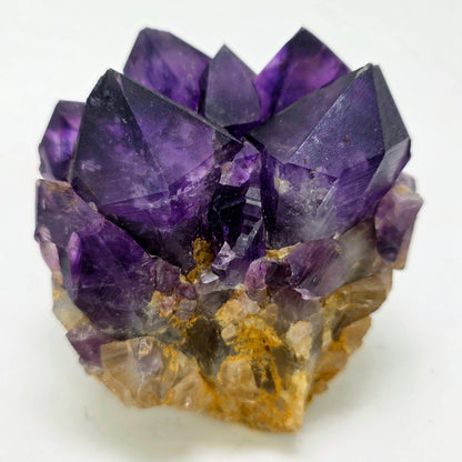Amethyst crystal cluster on a white background