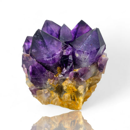Amethyst crystal cluster on a white background