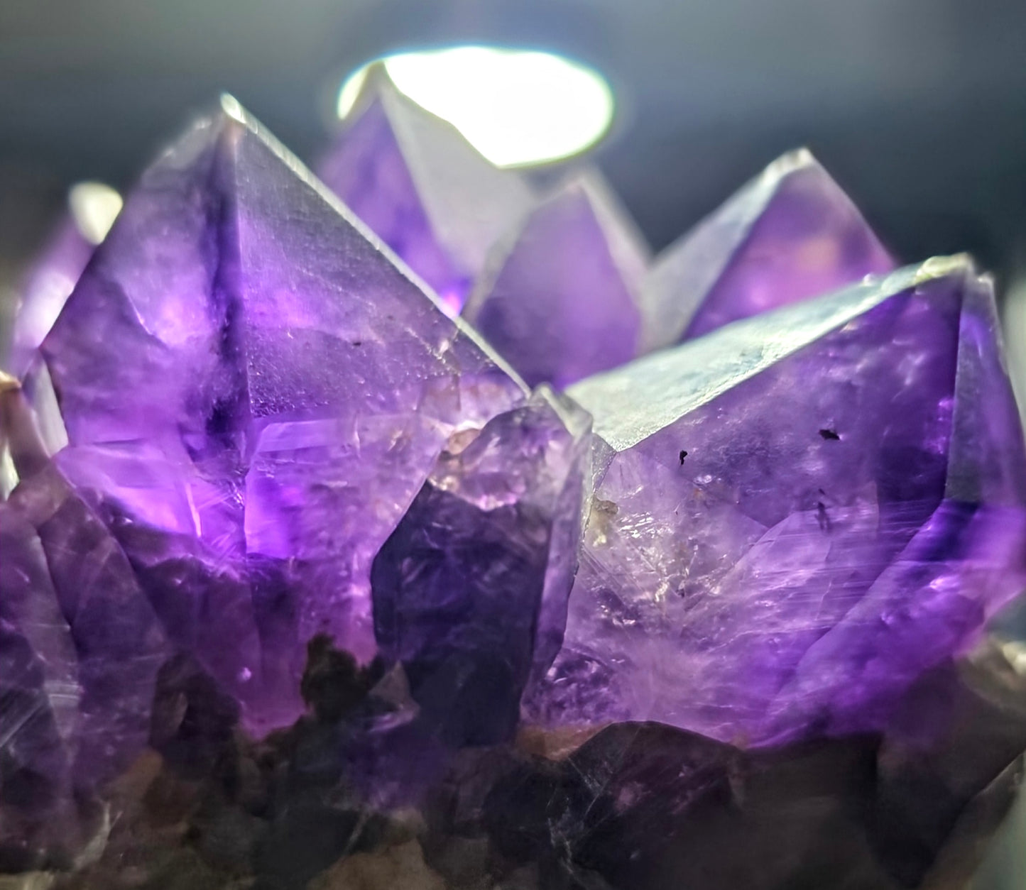 Close-up of purple crystal formations against a dark background