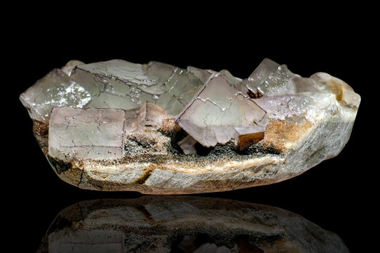 Mineral specimen with crystal formations on a black background