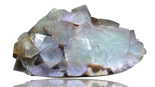 Crystal rock with clear and brownish crystals on a white background