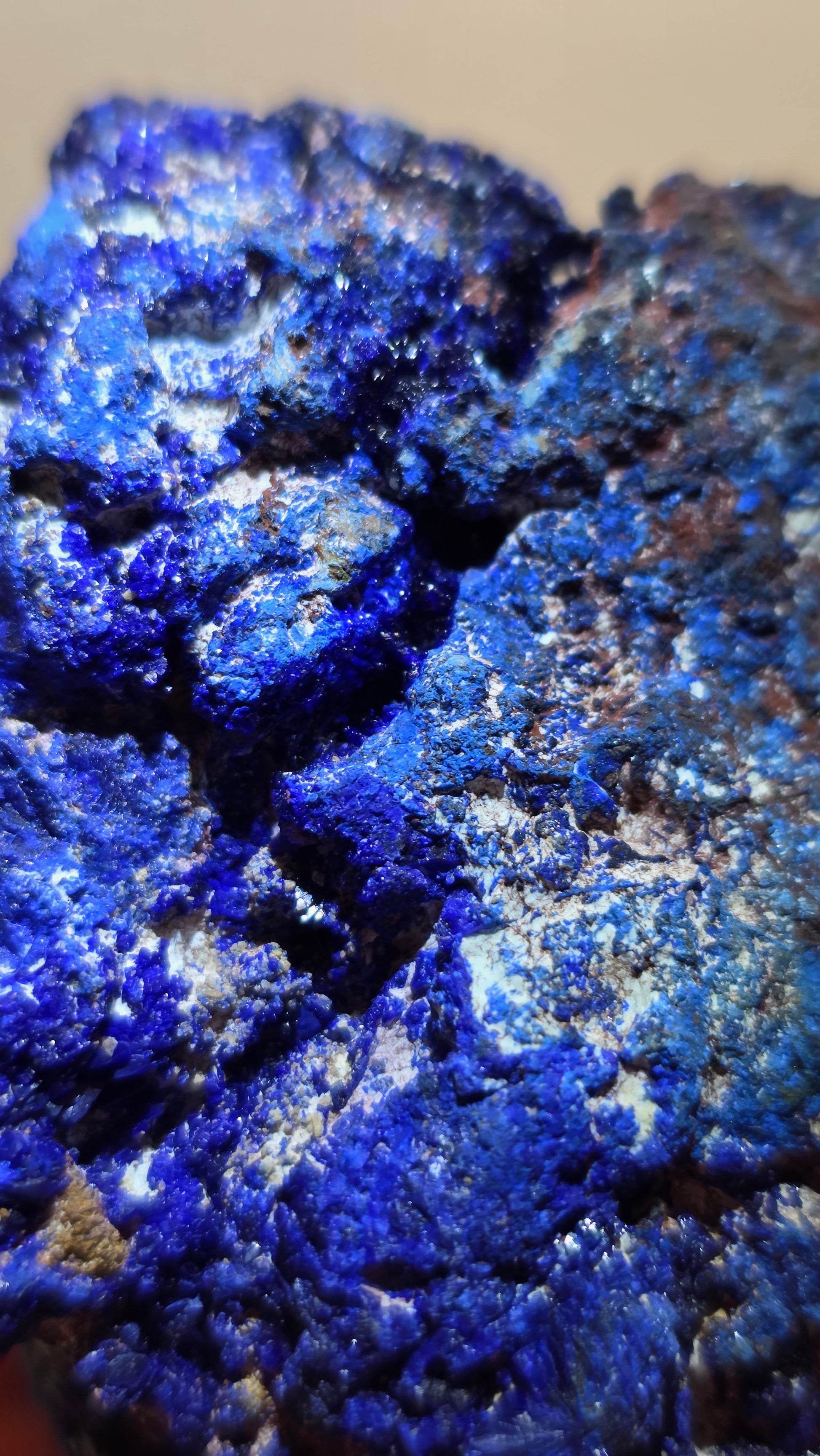 Close-up of blue mineral crystals on a beige background