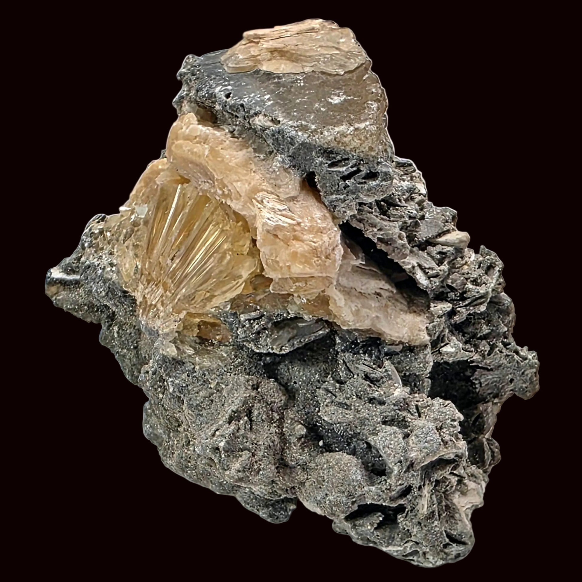 Mineral specimen with a central crystal on a white background