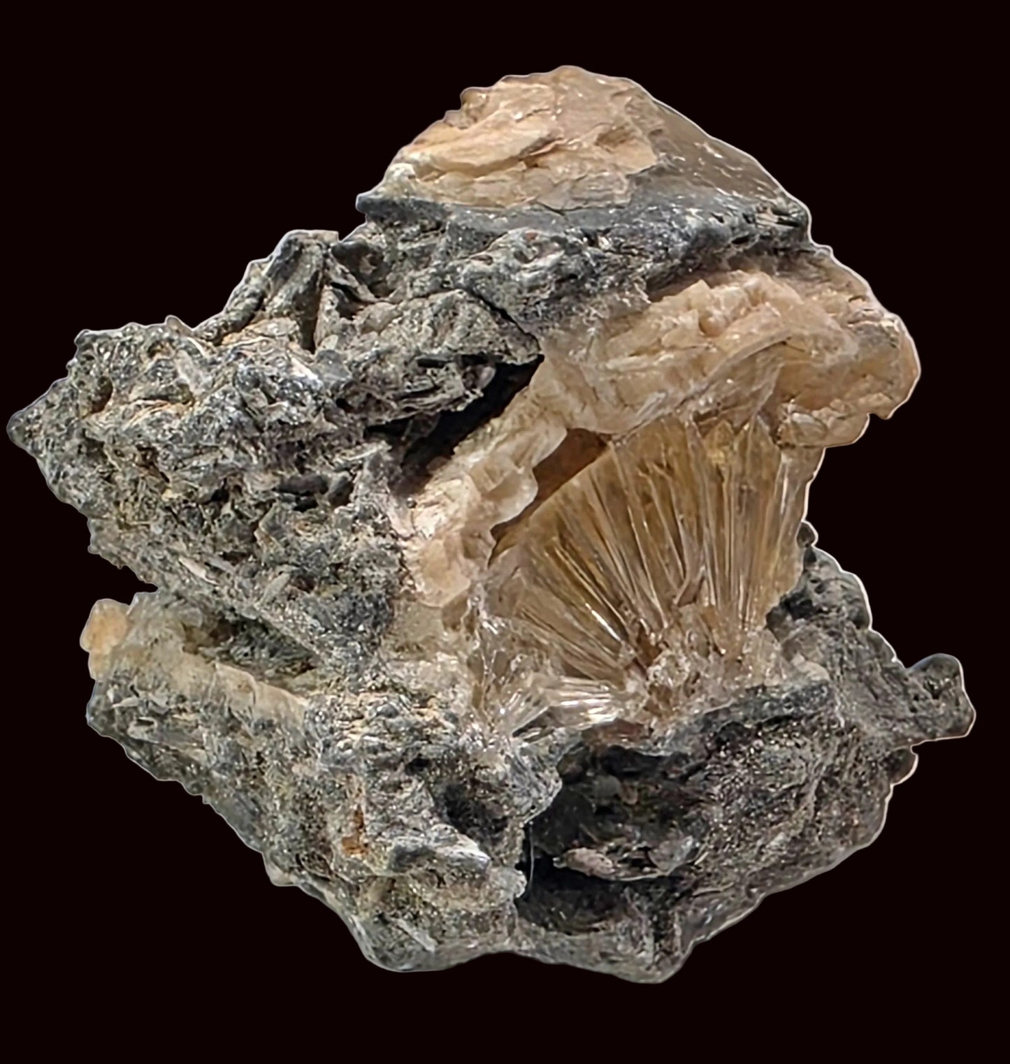 Mineral specimen with a central crystal on a gray background