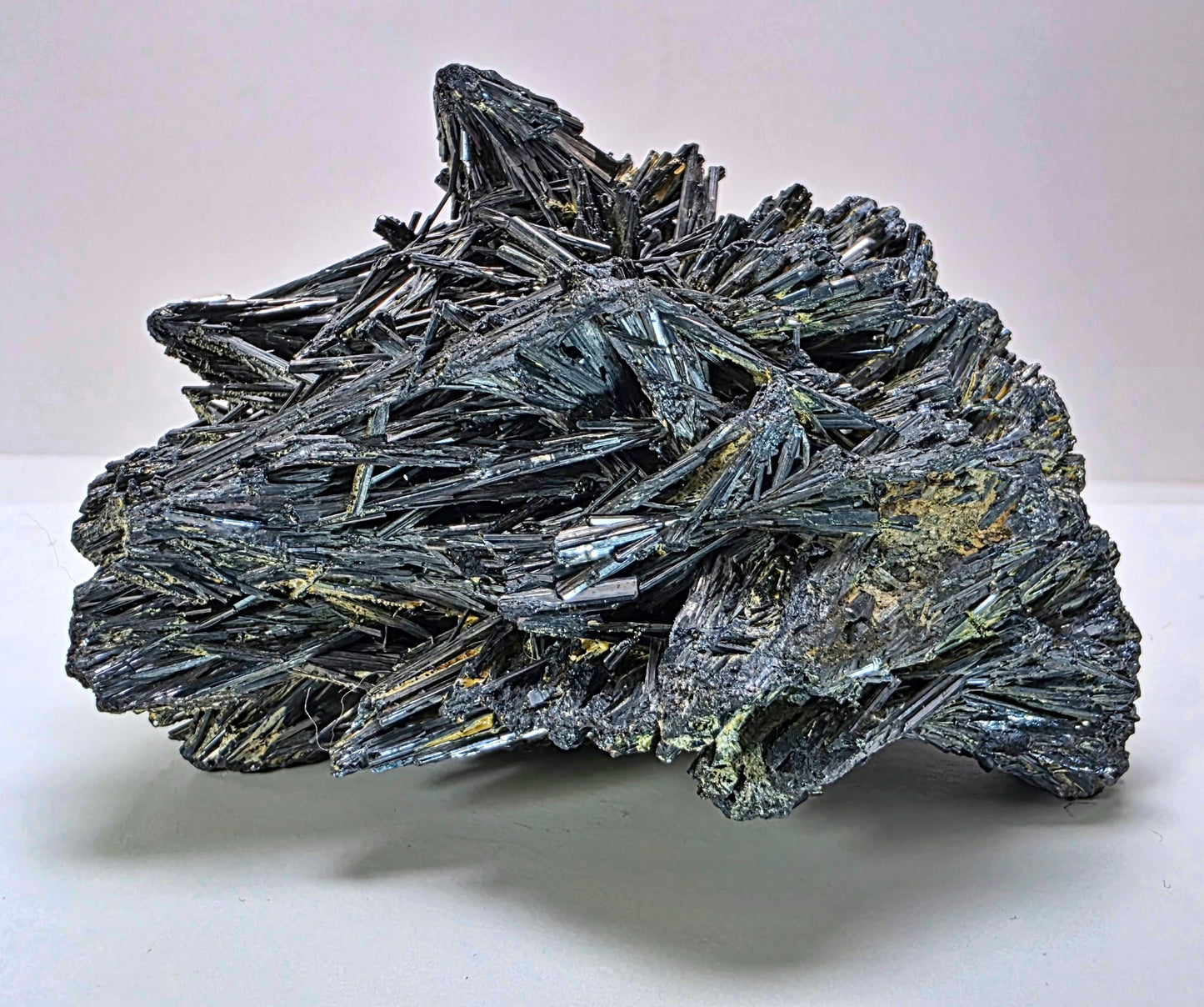 Mineral specimen with crystal formations on a white background