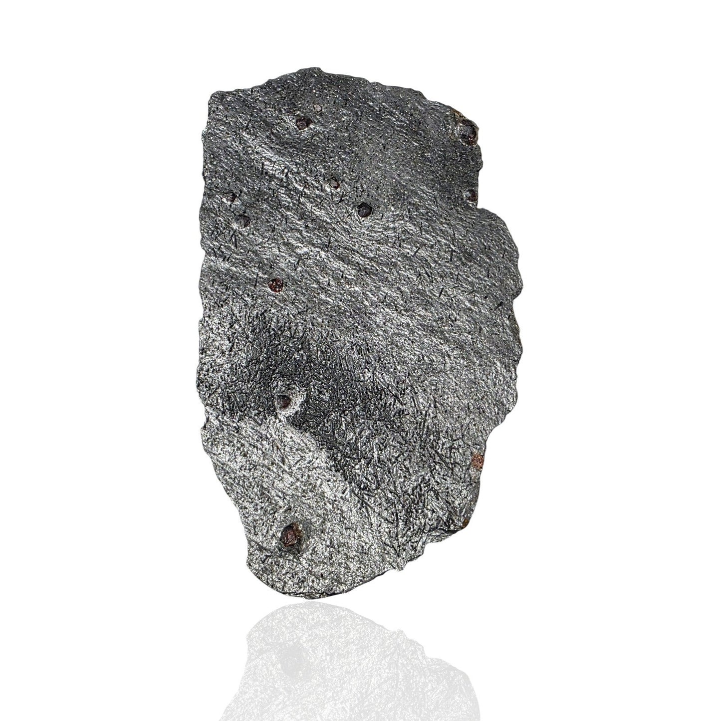 A raw, rough rectangular stone or mineral specimen with a textured, fibrous gray and black surface, shown on a clean white background with a soft reflection below.