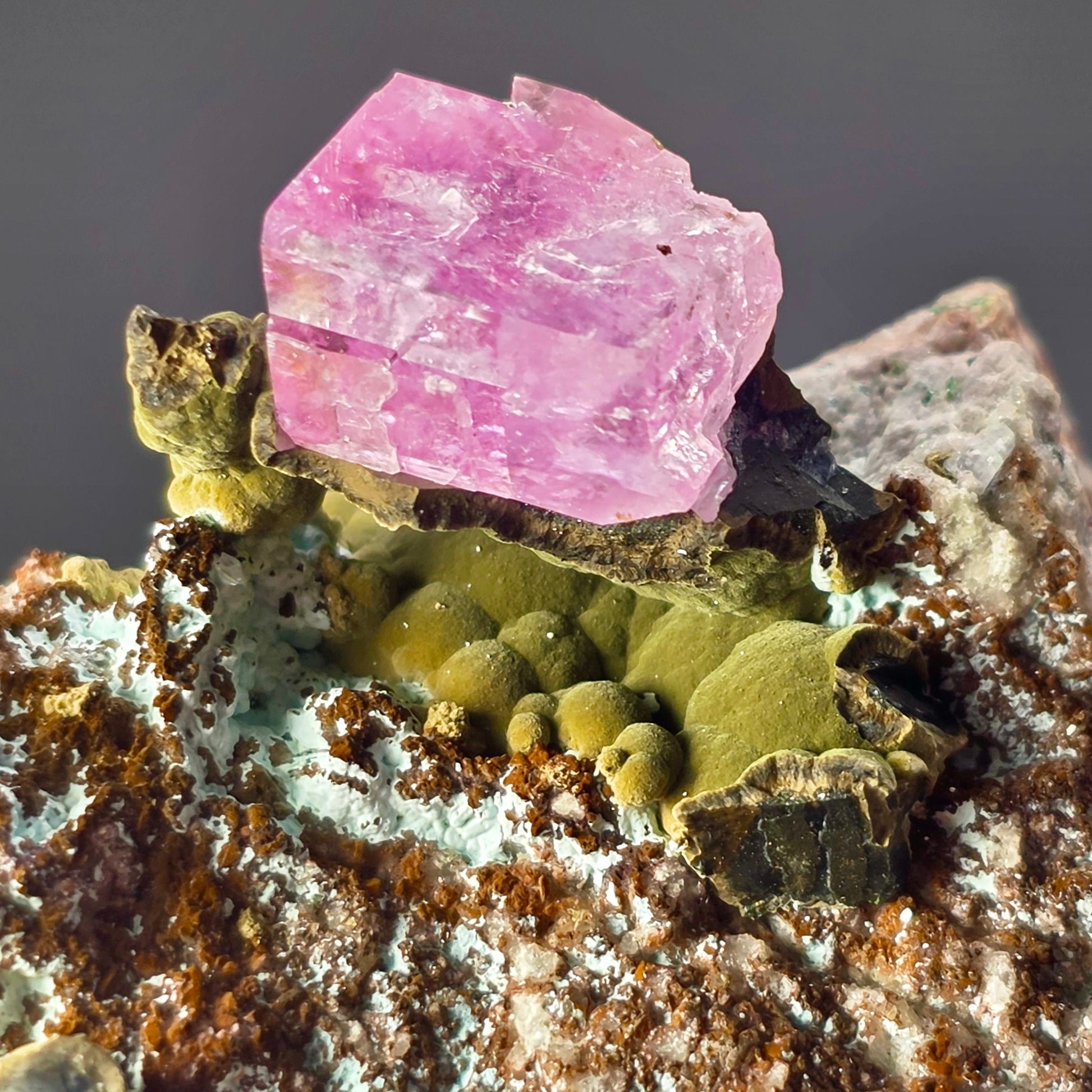 Pink crystal on a rock with a blurred background