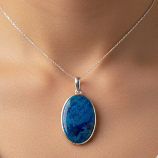 Necklace with a blue pendant on a neutral background