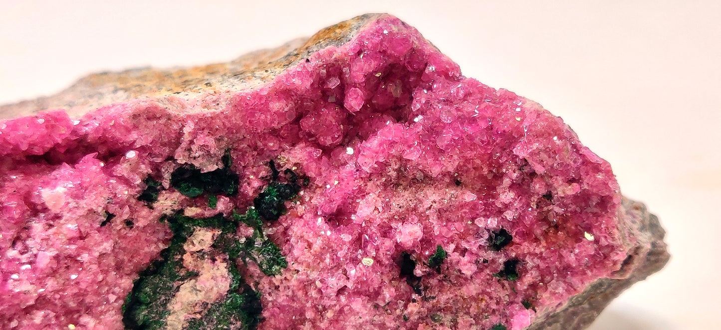 Close-up of a pink mineral crystal on a white background