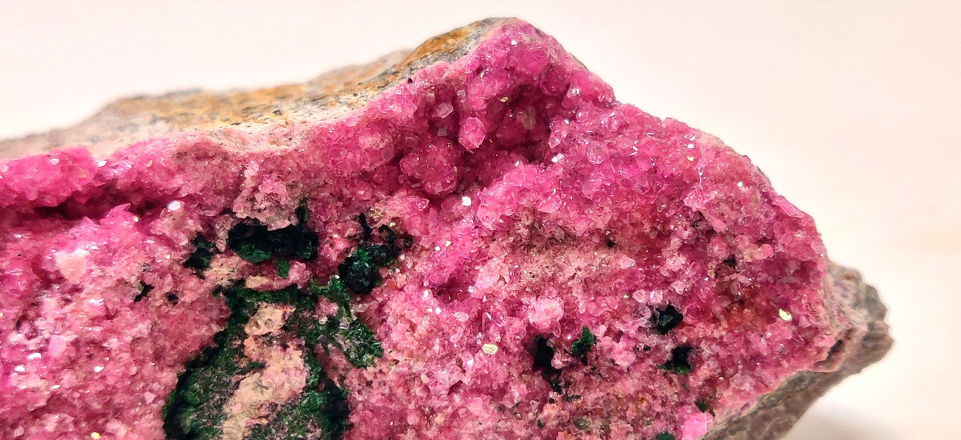Close-up of a pink mineral crystal on a white background