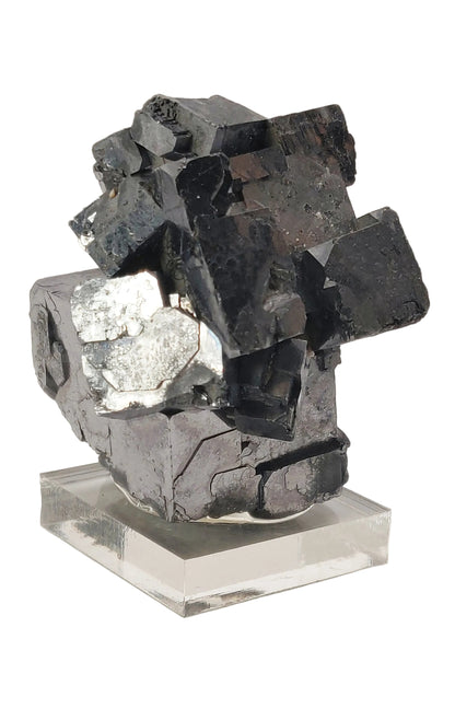 Mineral specimen on a clear base against a white background