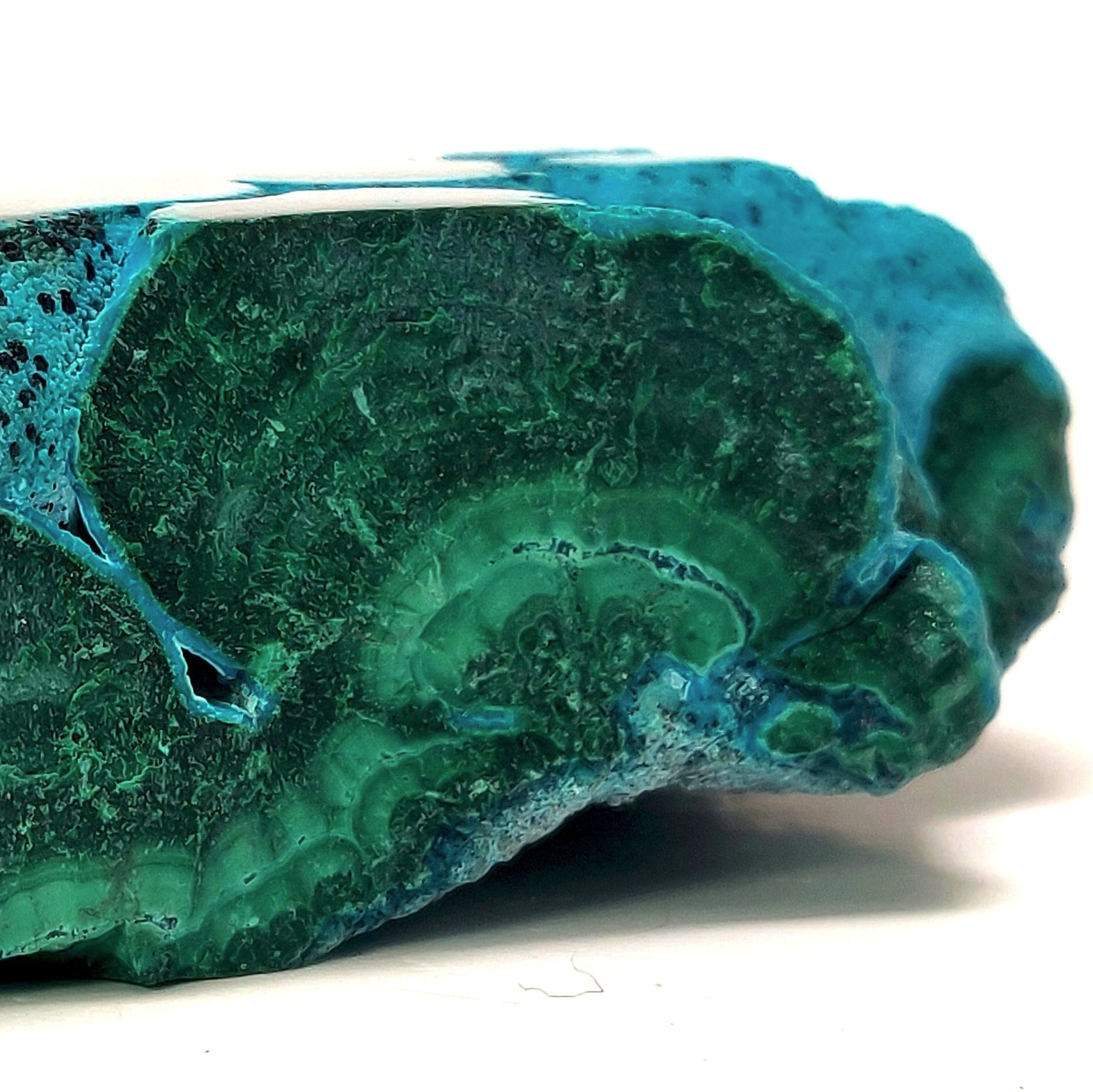 Blue-green mineral stone on a white background
