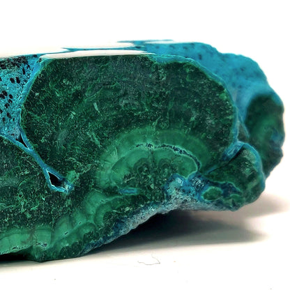 Blue-green mineral stone on a white background
