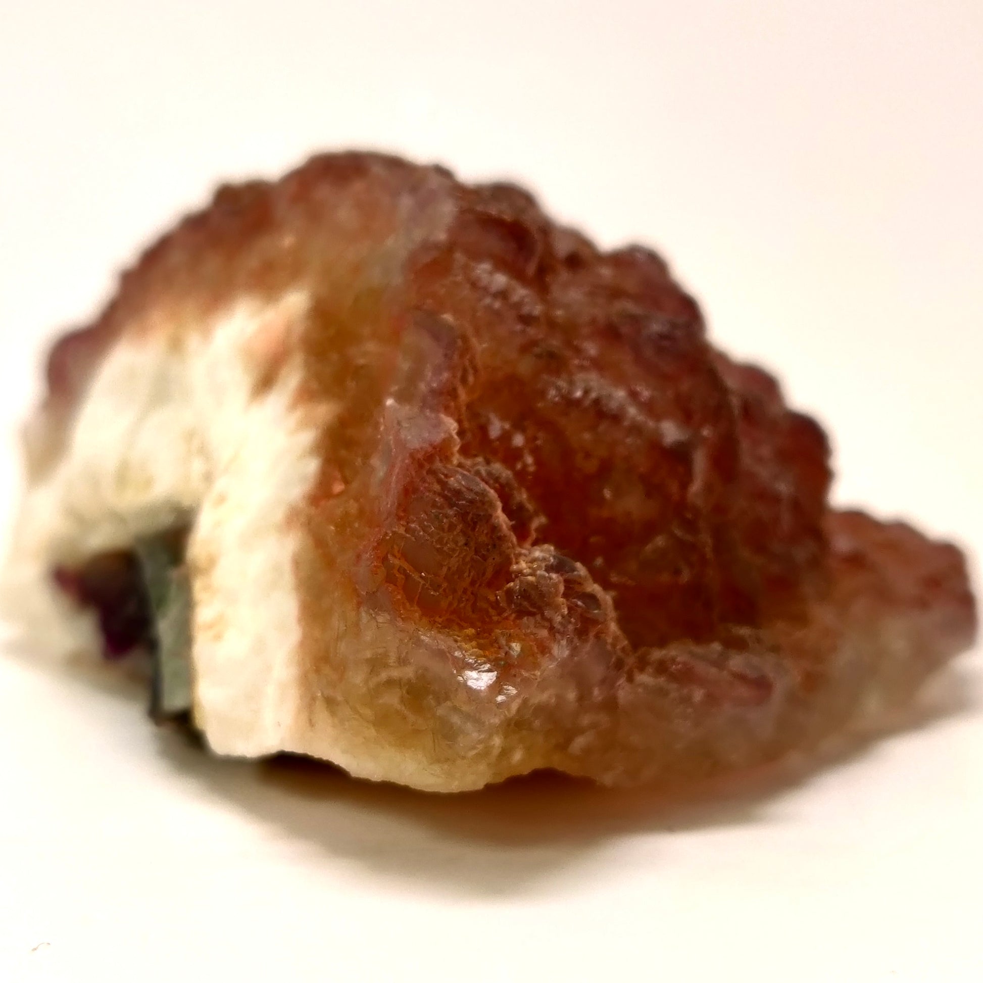 Close-up of a brown crystal rock on a white background