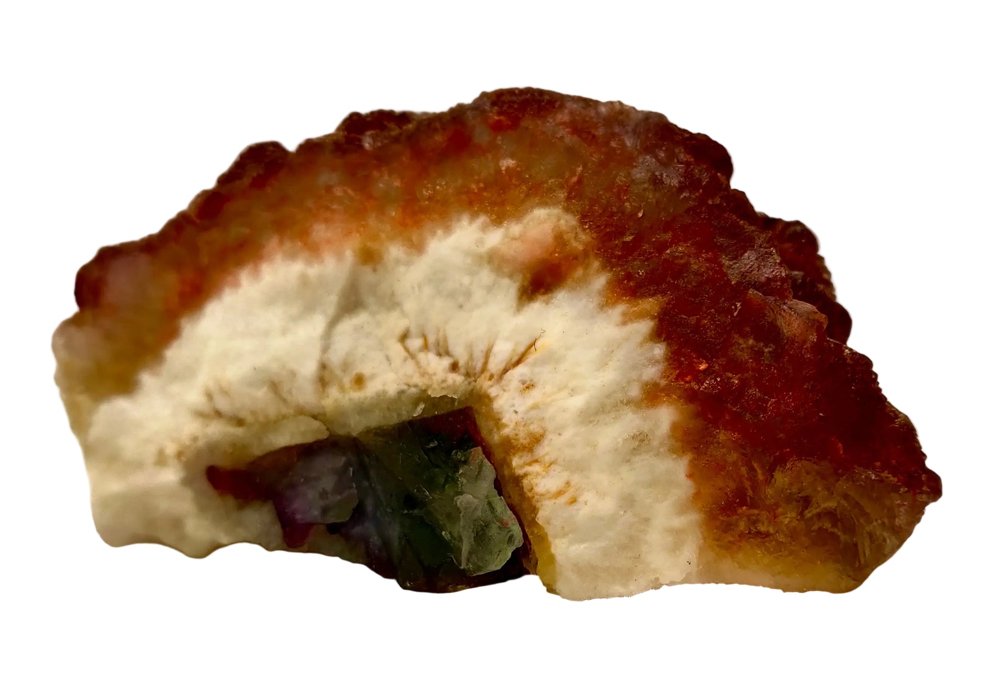Mineral sample with a white center and brownish-red outer layer on a beige background