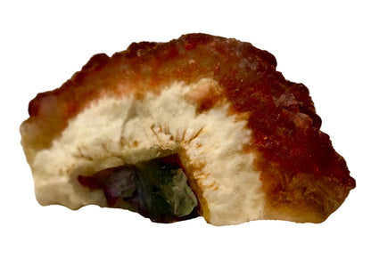 Mineral sample with a white center and brownish-red outer layer on a beige background