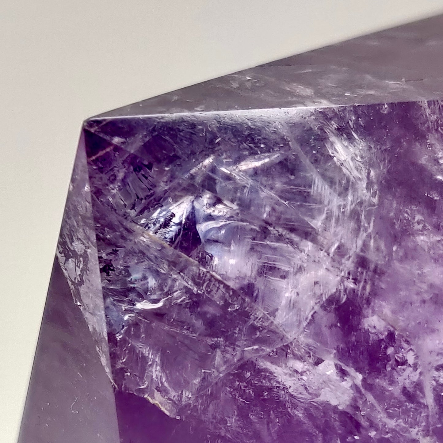 Close-up of a purple crystal with a white background