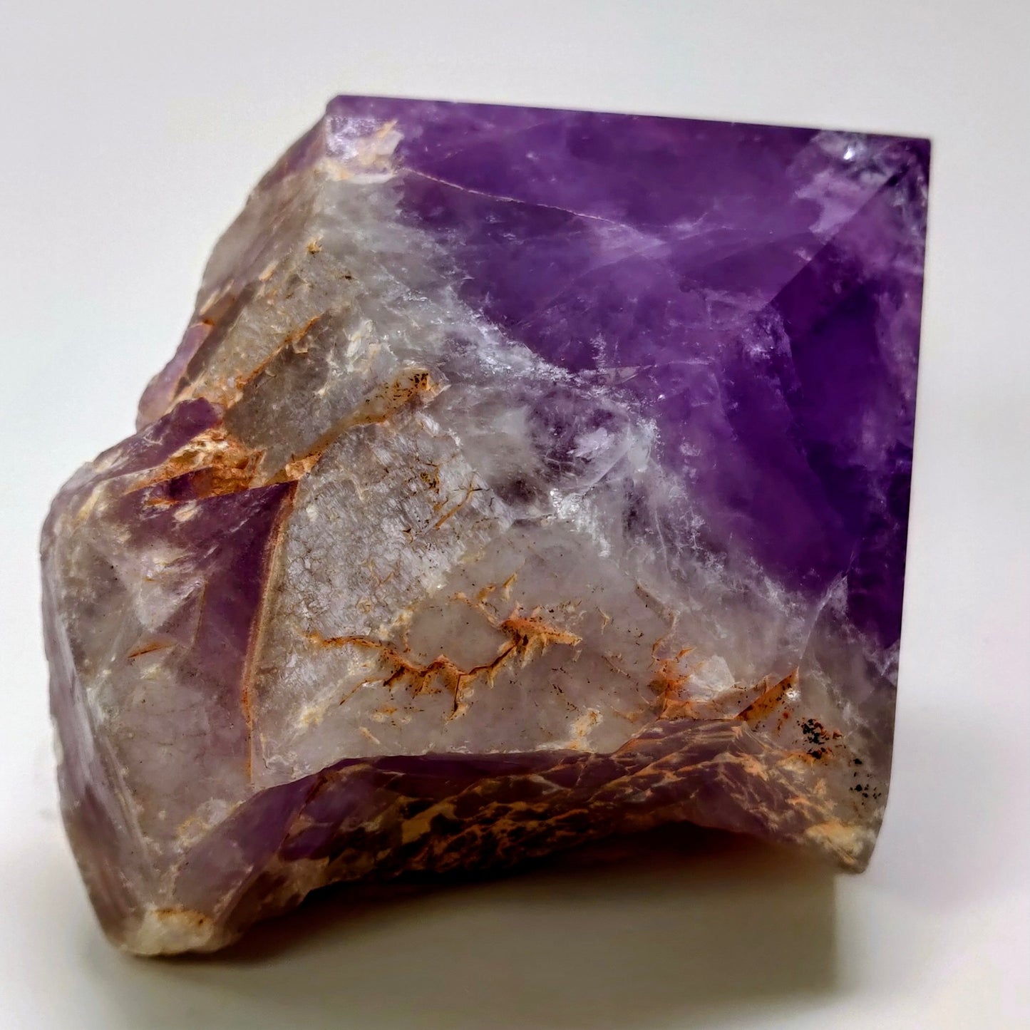 Purple crystal with visible veins on a white background