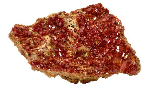 Red mineral specimen on a beige background