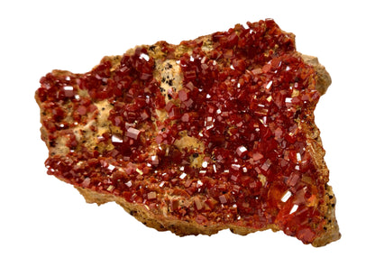 Red crystal mineral on a beige background