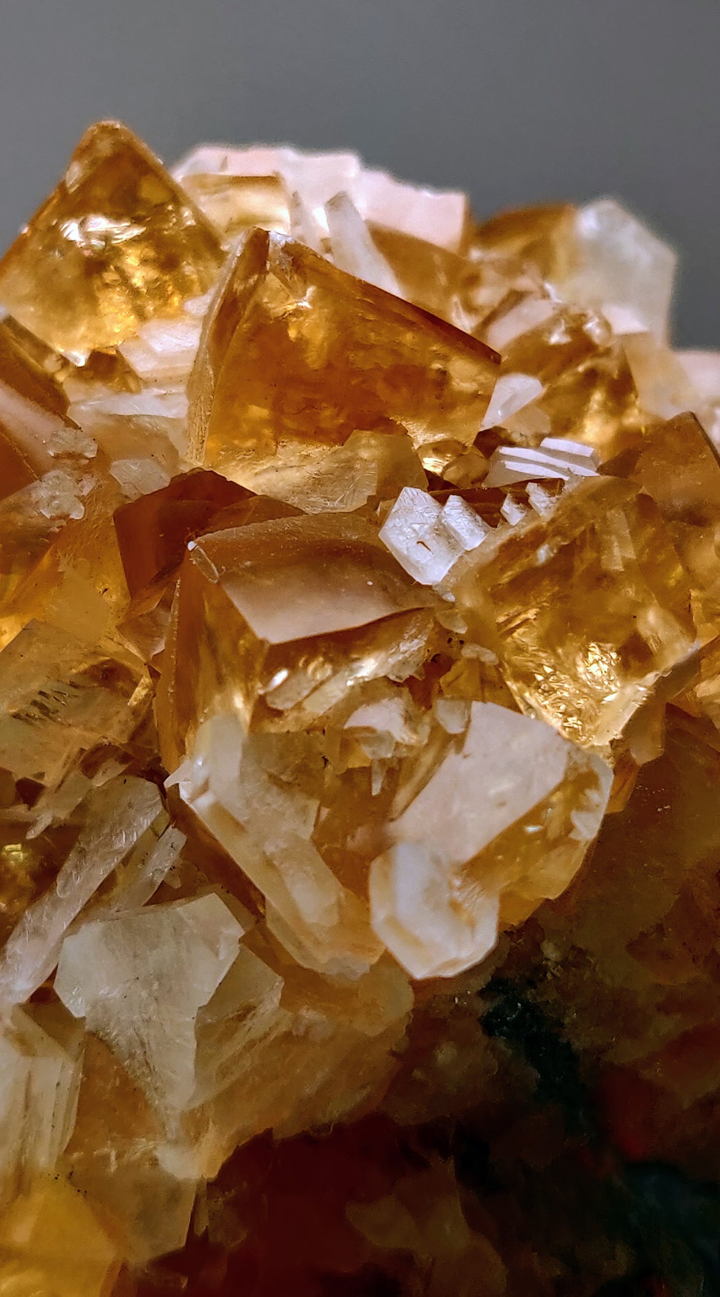 Close-up of crystalline mineral cluster with yellow and clear crystals.