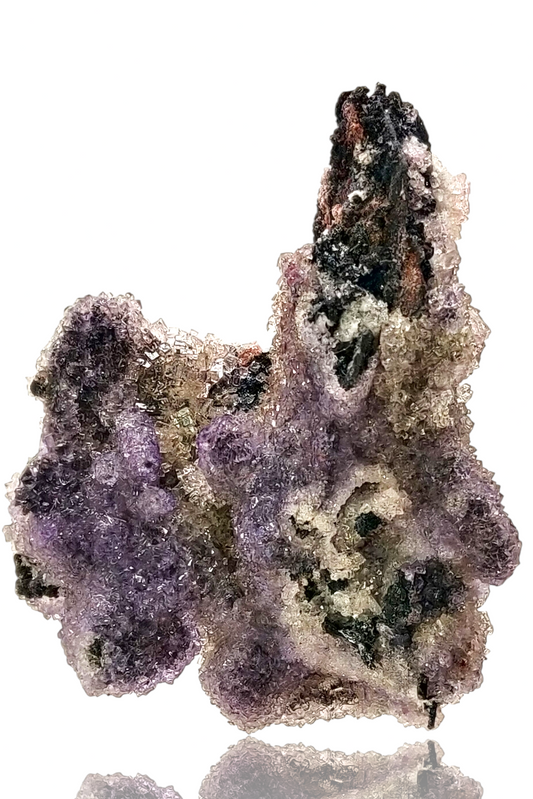 Mineral specimen with purple and brown colors on a white background