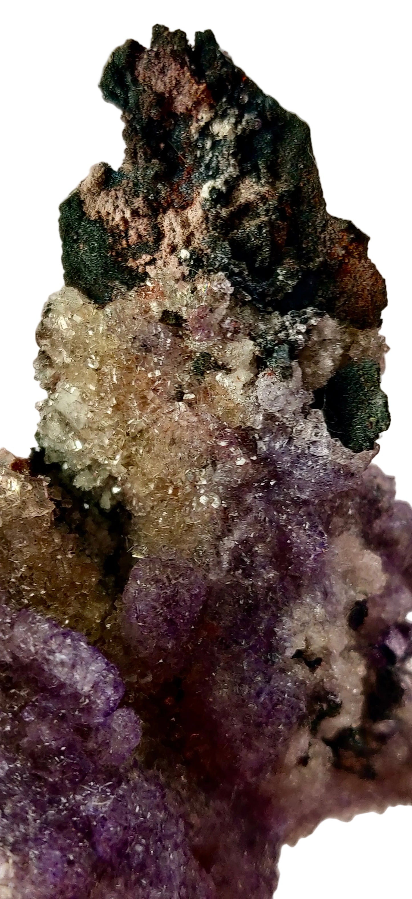 Mineral specimen with purple and green crystals on a beige background