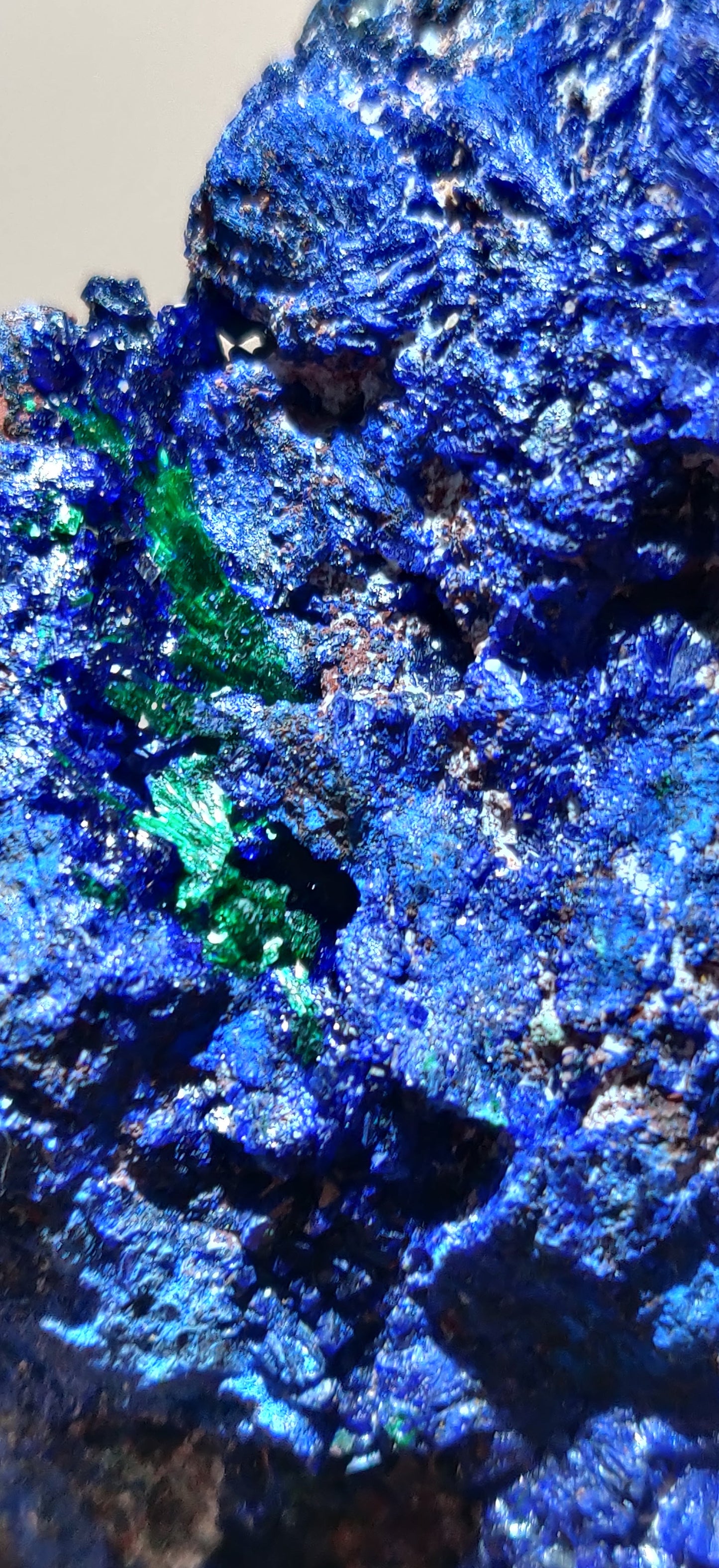 Close-up of blue and green mineral crystals on a dark background