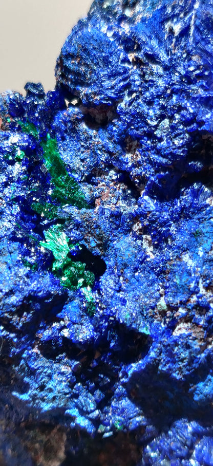 Close-up of blue and green mineral crystals on a dark background