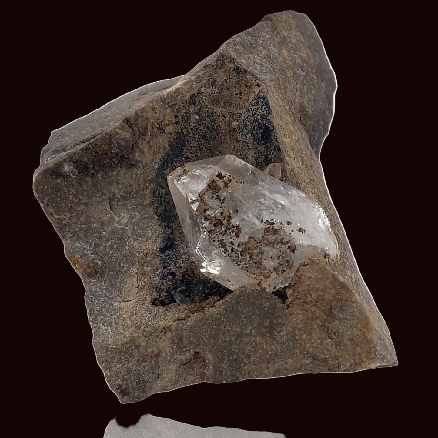 Crystal embedded in a rough stone on a white background