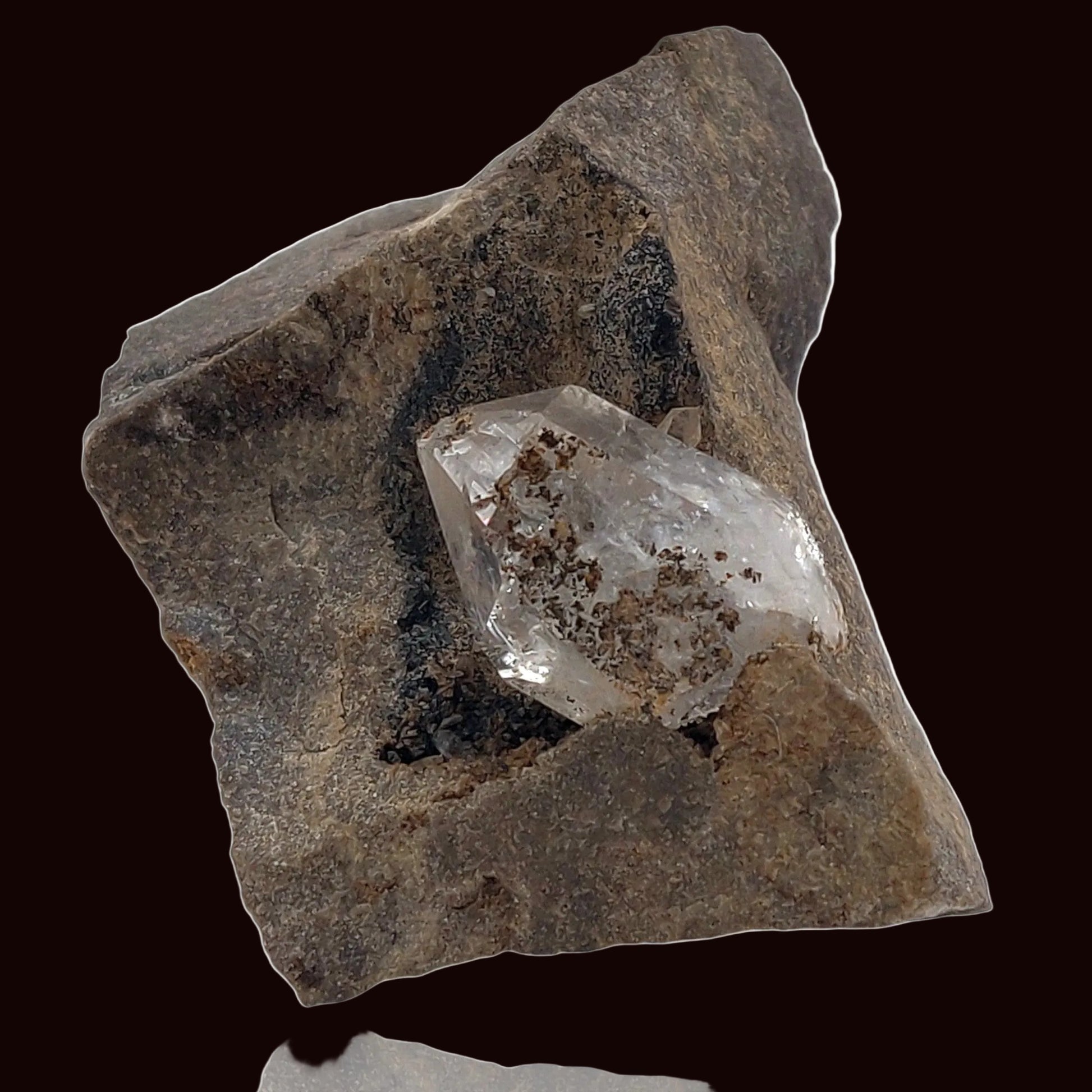 Crystal embedded in a rough stone on a white background