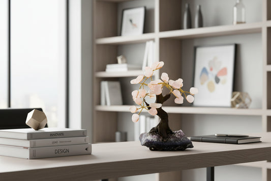 Decorative stone bonsai tree with pink stones on a white background
